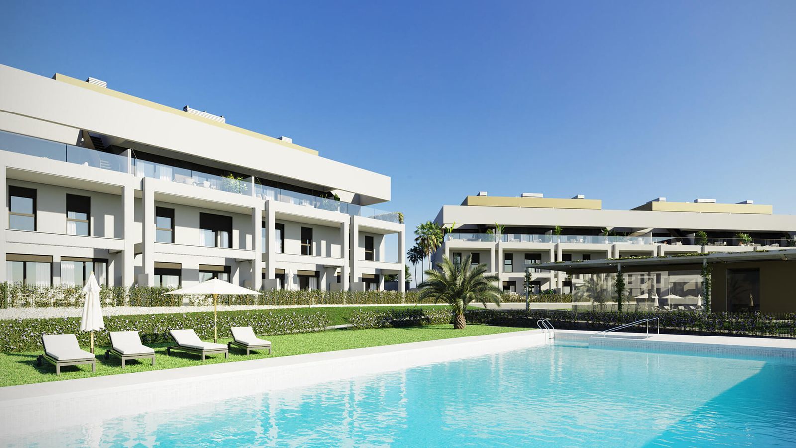 Symphony Suites: Zwembad met ligstoelen en uitzicht op de appartementen.